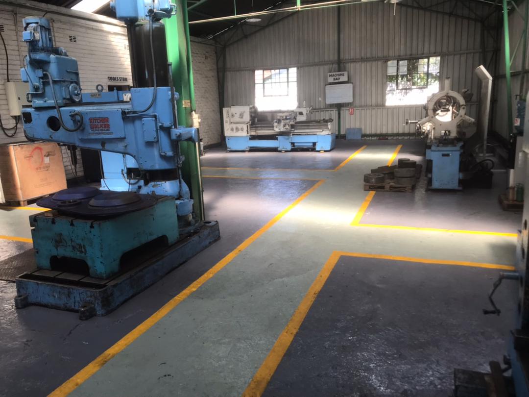 IMG-20240402-WA0009 Industrial workshop with machining equipment and marked safety walkways, supporting engineering solutions for mining and heavy industries.